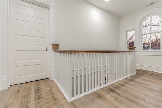 hall with light hardwood / wood-style floors