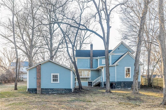 rear view of property with a yard