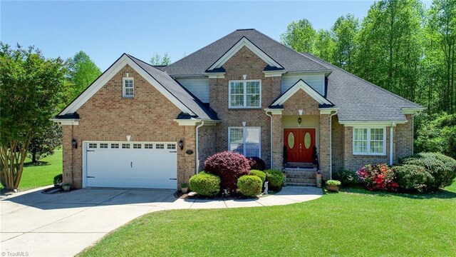 226 Marshview Cir, Angier, NC 27501 - view of front of home with a shingled roof, a front lawn, an attached garage, driveway, and brick siding