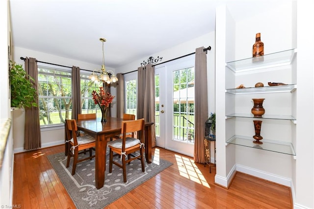 226 Marshview Cir, Angier, NC 27501 - dining room featuring light wood finished floors, baseboards, and an inviting chandelier