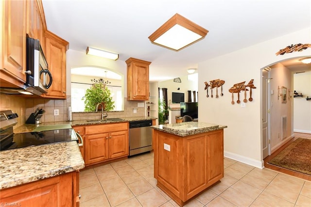 226 Marshview Cir, Angier, NC 27501 - kitchen featuring light tile patterned floors, a sink, a center island, tasteful backsplash, and appliances with stainless steel finishes