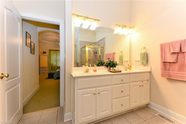 226 Marshview Cir, Angier, NC 27501 - ensuite bathroom featuring a shower stall, tile patterned floors, double vanity, visible vents, and baseboards