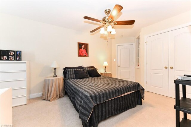 226 Marshview Cir, Angier, NC 27501 - bedroom featuring a closet, a ceiling fan, baseboards, and light carpet