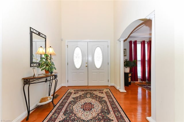 226 Marshview Cir, Angier, NC 27501 - foyer with plenty of natural light, decorative columns, arched walkways, and light wood-style floors