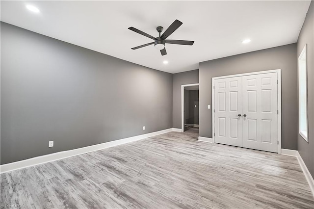 unfurnished bedroom with a closet, ceiling fan, and light hardwood / wood-style floors