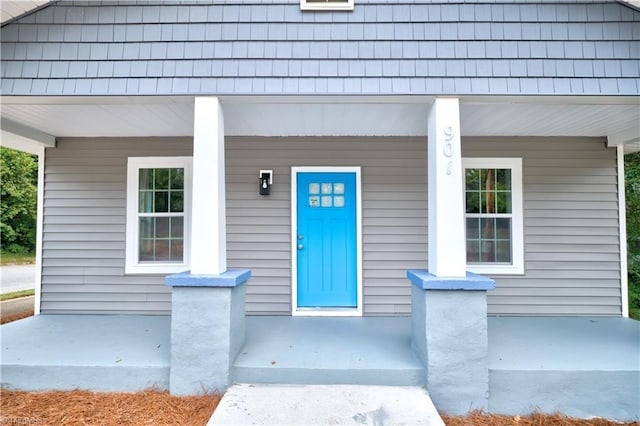 view of exterior entry with a porch