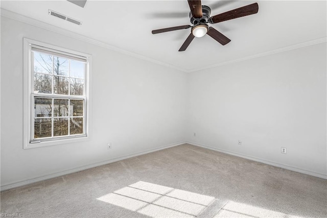 carpeted empty room featuring ceiling fan and ornamental molding