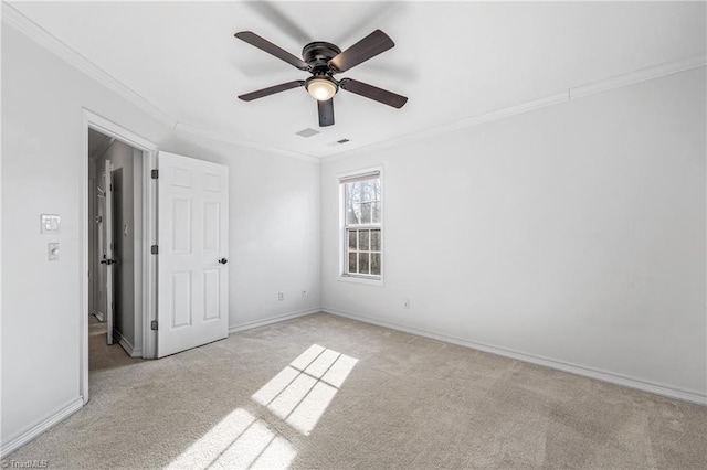 carpeted empty room featuring crown molding and ceiling fan