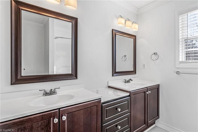 bathroom with ornamental molding and vanity