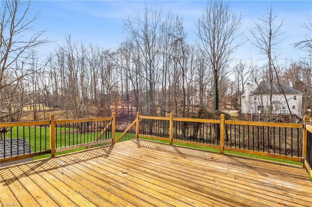 wooden terrace featuring a lawn