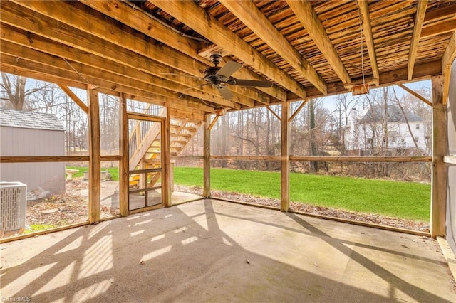 unfurnished sunroom featuring ceiling fan