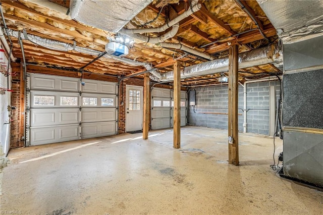 garage with a garage door opener, heating unit, and electric panel