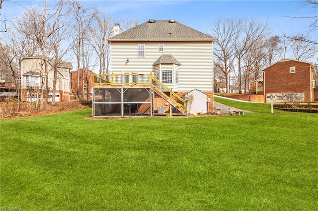 rear view of house featuring a wooden deck, central AC, a lawn, and a sunroom