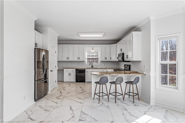 kitchen with black appliances, white cabinetry, a kitchen breakfast bar, and kitchen peninsula