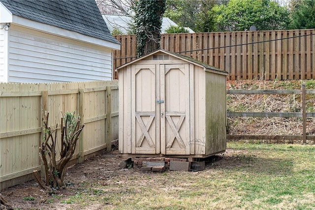 view of shed featuring a fenced backyard