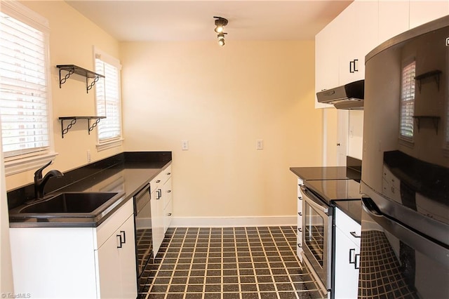 kitchen featuring stainless steel electric range, a sink, white cabinets, under cabinet range hood, and dark countertops