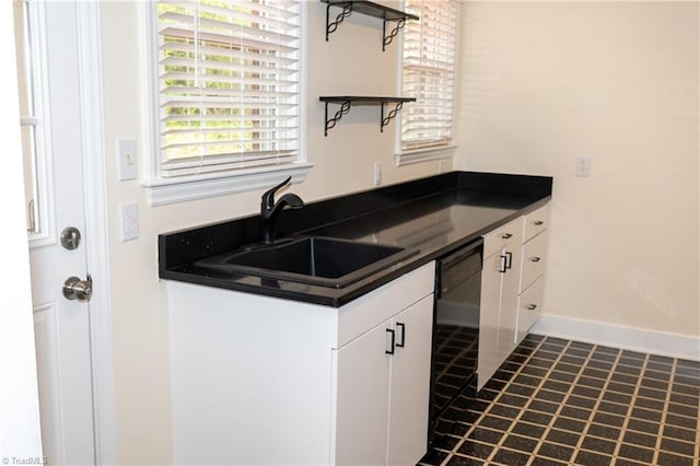 kitchen with open shelves, a sink, white cabinets, dishwasher, and dark countertops