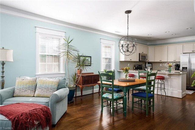 26 Vintage Ave, Winston-Salem, NC 27127 - dining space with dark wood-type flooring, ornamental molding, a chandelier, and a healthy amount of sunlight