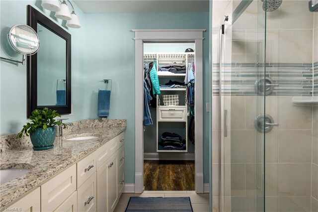 26 Vintage Ave, Winston-Salem, NC 27127 - bathroom featuring a shower stall, a walk in closet, double vanity, and a sink