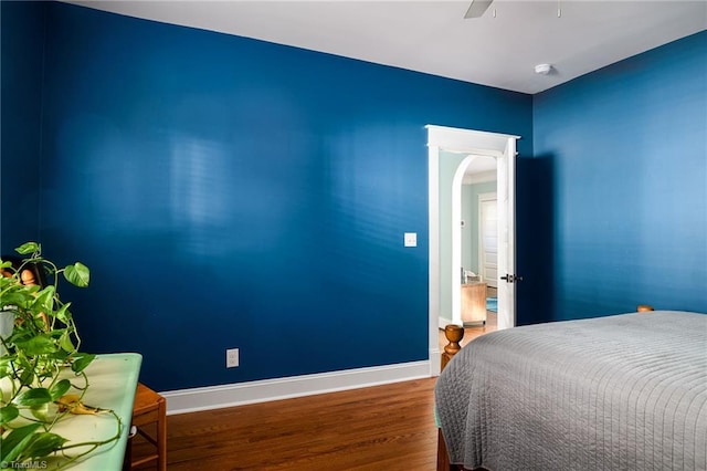 26 Vintage Ave, Winston-Salem, NC 27127 - bedroom with baseboards, arched walkways, ceiling fan, and wood finished floors