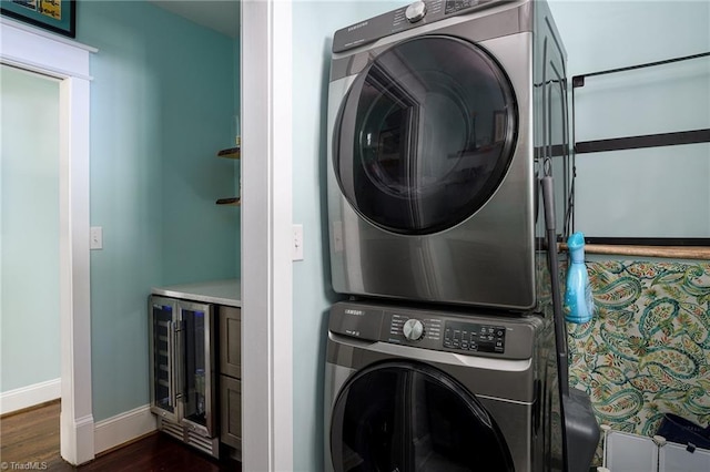 26 Vintage Ave, Winston-Salem, NC 27127 - clothes washing area with baseboards, dark wood finished floors, stacked washer / drying machine, laundry area, and wine cooler