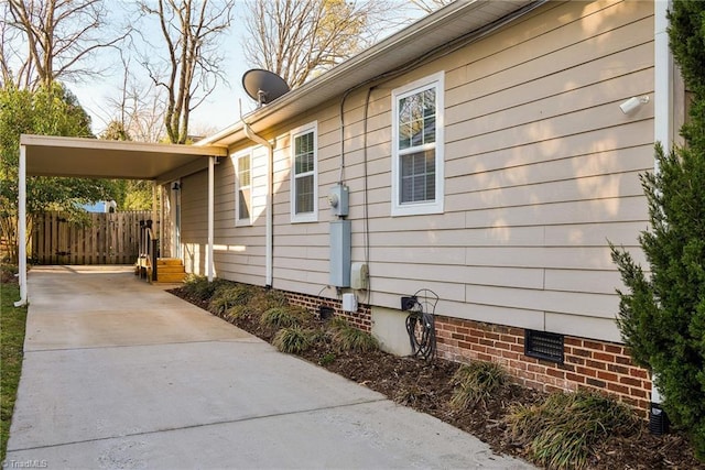 26 Vintage Ave, Winston-Salem, NC 27127 - view of property exterior featuring a carport, concrete driveway, and fence