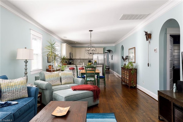 26 Vintage Ave, Winston-Salem, NC 27127 - living room with visible vents, arched walkways, an inviting chandelier, and dark wood-style floors