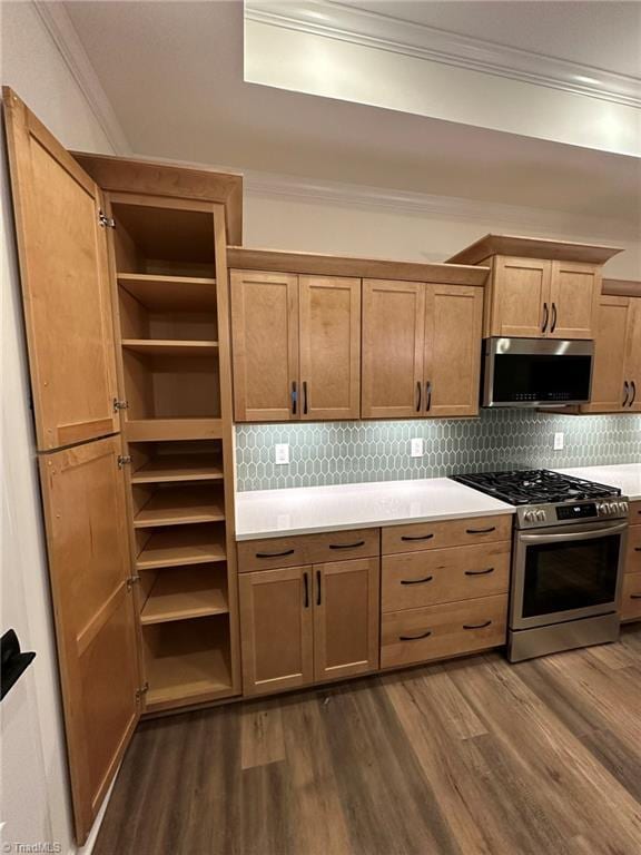 kitchen featuring dark wood-style floors, crown molding, open shelves, stainless steel appliances, and light countertops