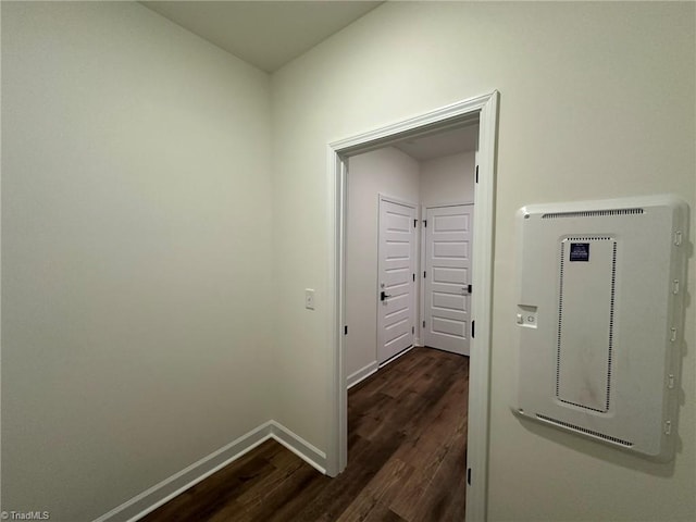 hall featuring dark wood-style floors and baseboards