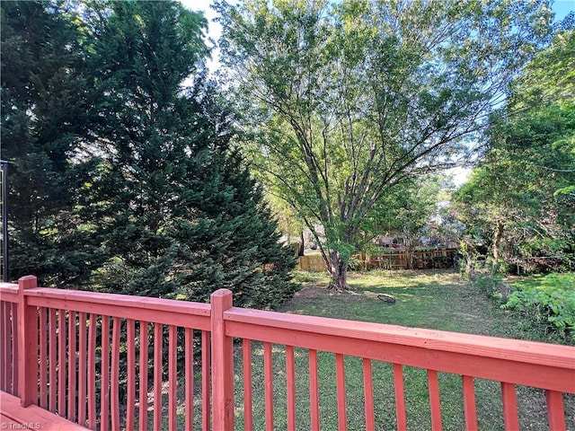deck featuring a yard and fence