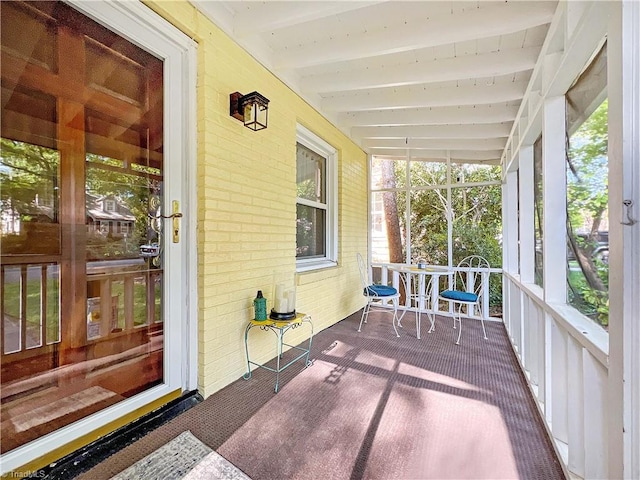 sunroom / solarium with beamed ceiling