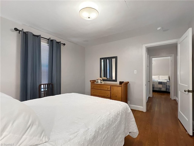 bedroom featuring baseboards and wood finished floors
