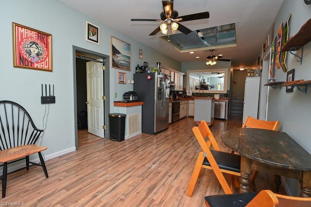 dining area featuring light wood finished floors and a ceiling fan