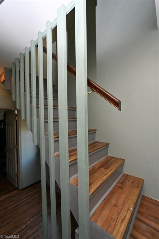 staircase featuring wood finished floors