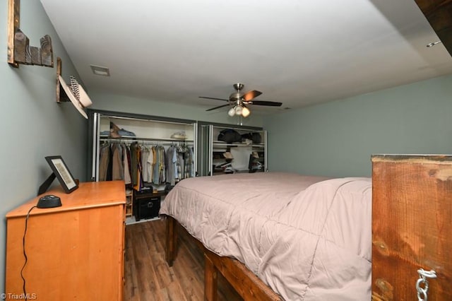 bedroom featuring a closet, wood finished floors, visible vents, and ceiling fan
