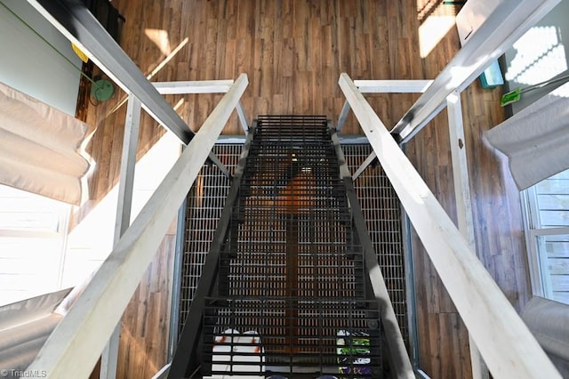 stairs featuring wood walls