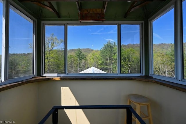 unfurnished sunroom with a view of trees