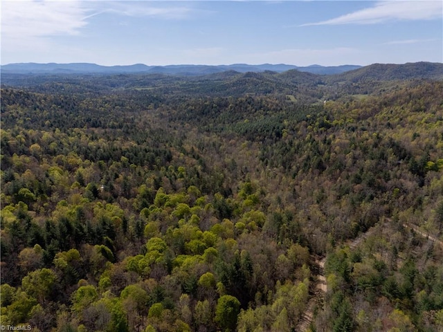 aerial view with a wooded view and a mountain view