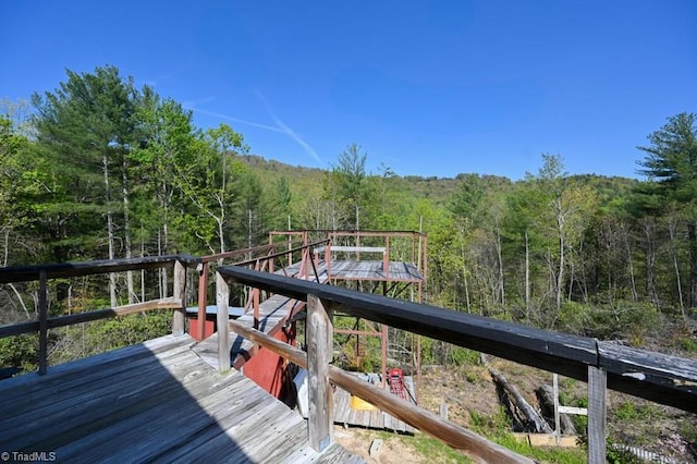 wooden terrace with a wooded view