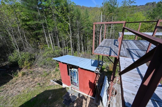 exterior space featuring a wooded view
