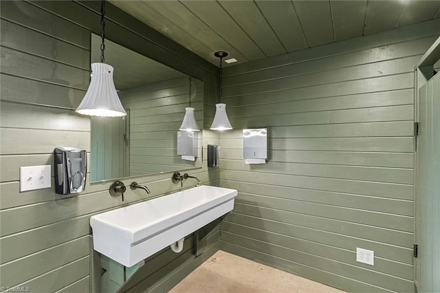 bathroom with wooden ceiling and wooden walls