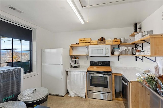 kitchen with stainless steel appliances and light colored carpet