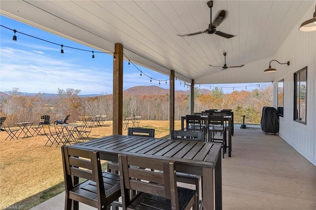 view of patio with a mountain view and ceiling fan