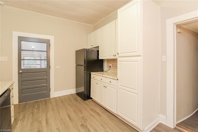 323 Anderson Rd, Eden, NC 27288 - kitchen featuring light wood-type flooring, black dishwasher, white cabinets, and freestanding refrigerator