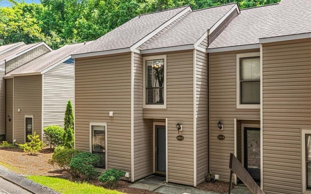 223 Village Ln Unit A, Greensboro, NC 27409 - townhome / multi-family property featuring a shingled roof