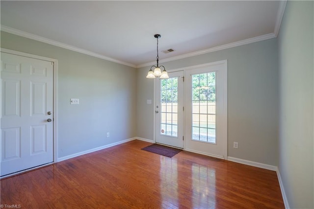 interior space with baseboards, wood finished floors, visible vents, and crown molding