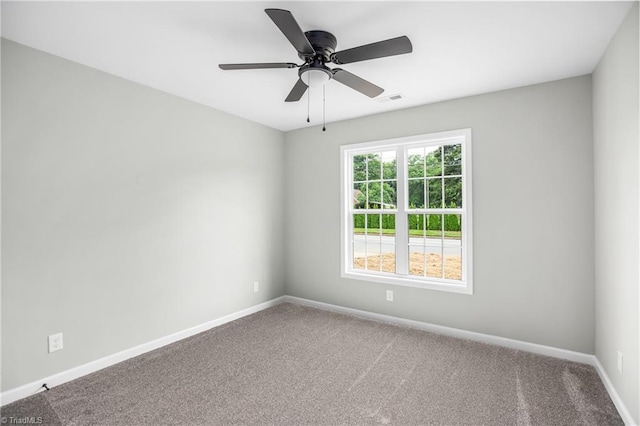 spare room featuring carpet flooring and ceiling fan