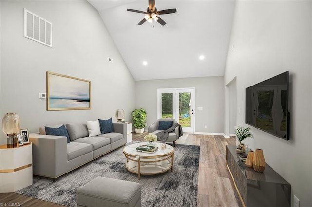 living room featuring wood-type flooring, high vaulted ceiling, and ceiling fan