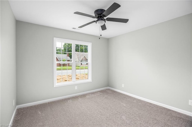 carpeted empty room featuring ceiling fan