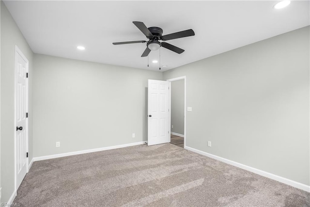 unfurnished room featuring ceiling fan and carpet